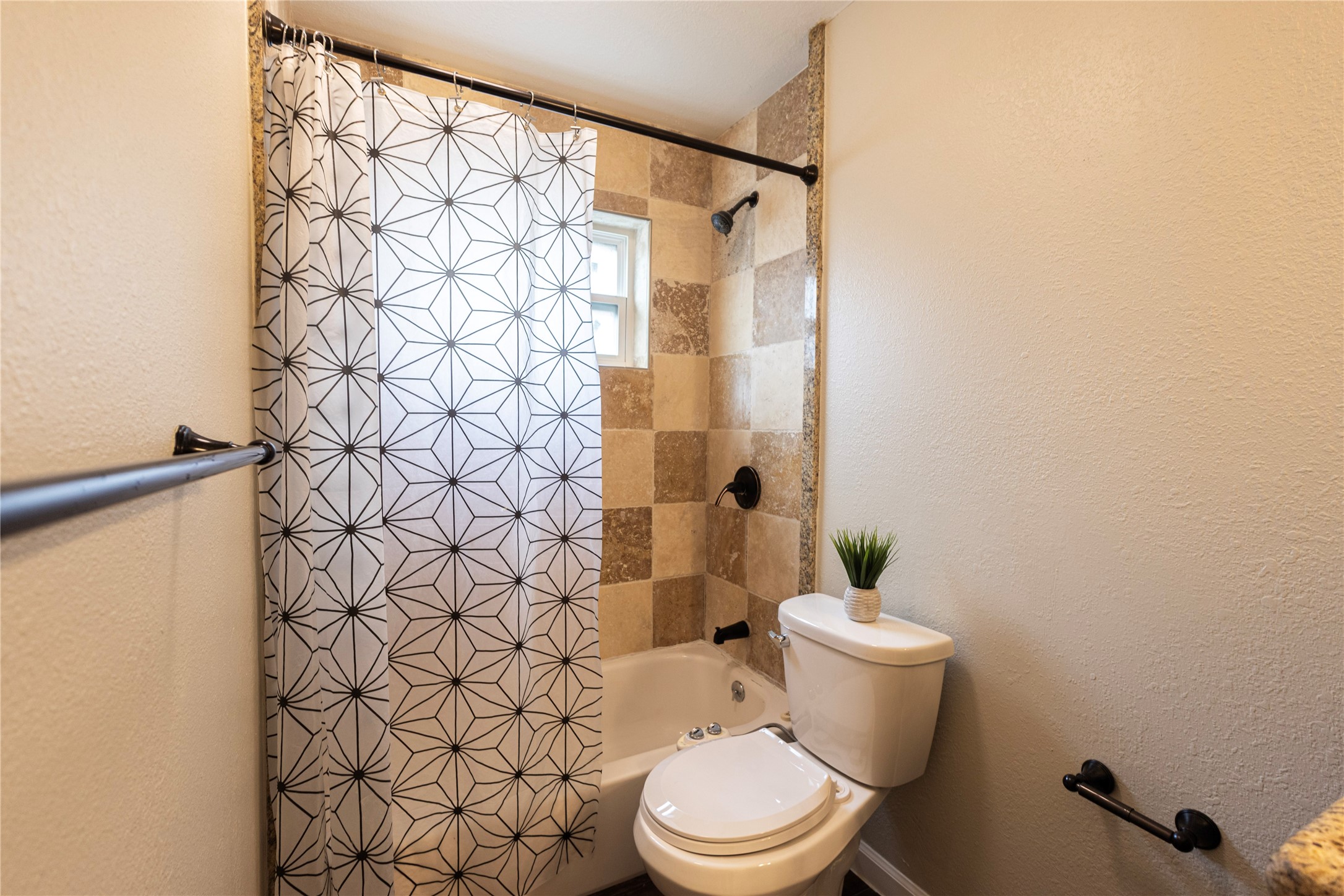 14419 Wadebridge Way Houston, TX 77015 - Photo 11 of 20 Here's a glimpse of the hallway's full bathroom, showcasing a sleek, modern design with elegant neutral tones.
