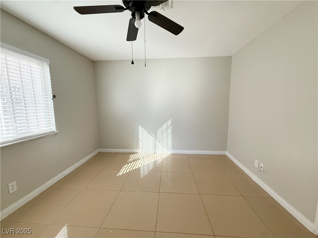 2353 Exeter Drive, Unit B Las Vegas, NV 89156 - Photo 11 of 16 Tiled spare room with baseboards and a ceiling fan