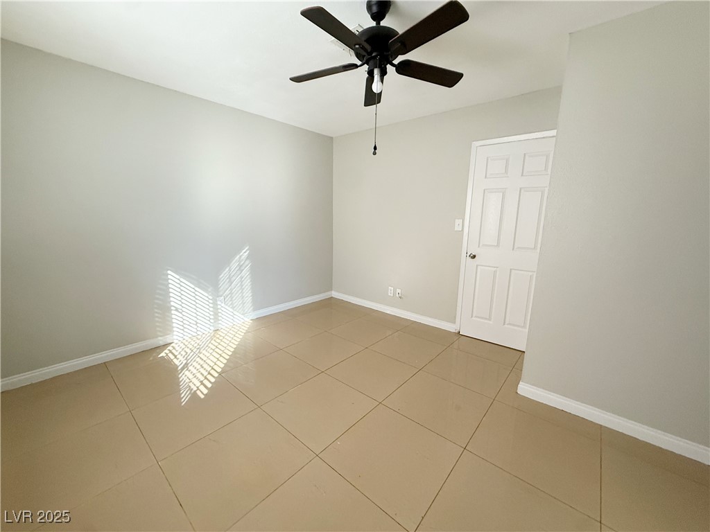 2353 Exeter Drive, Unit B Las Vegas, NV 89156 - Photo 12 of 16 Spare room featuring light tile patterned floors and a ceiling fan