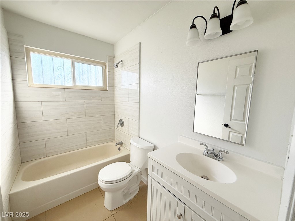 2353 Exeter Drive, Unit B Las Vegas, NV 89156 - Photo 15 of 16 Full bathroom with shower combination, vanity, and light tile patterned floors