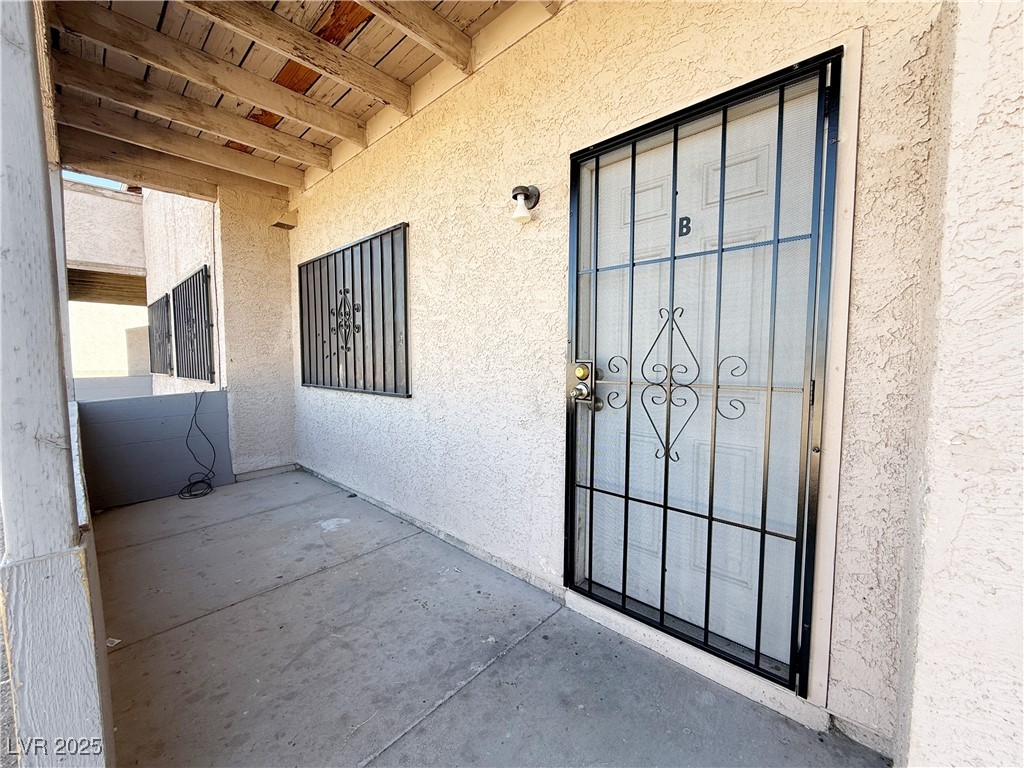 2353 Exeter Drive, Unit B Las Vegas, NV 89156 - Photo 2 of 16 Property entrance with stucco siding and a patio