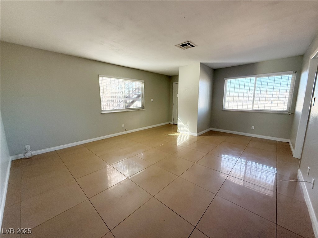 2353 Exeter Drive, Unit B Las Vegas, NV 89156 - Photo 3 of 16 Spare room with light tile patterned floors and plenty of natural light