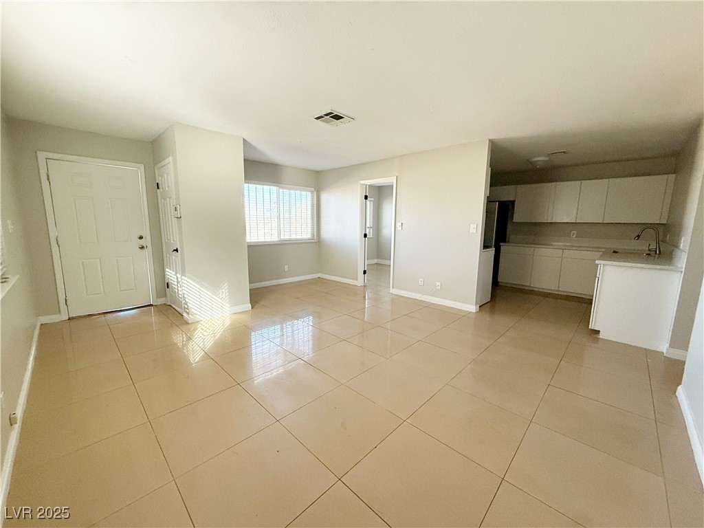 2353 Exeter Drive, Unit B Las Vegas, NV 89156 - Photo 4 of 16 Unfurnished living room featuring light tile patterned floors