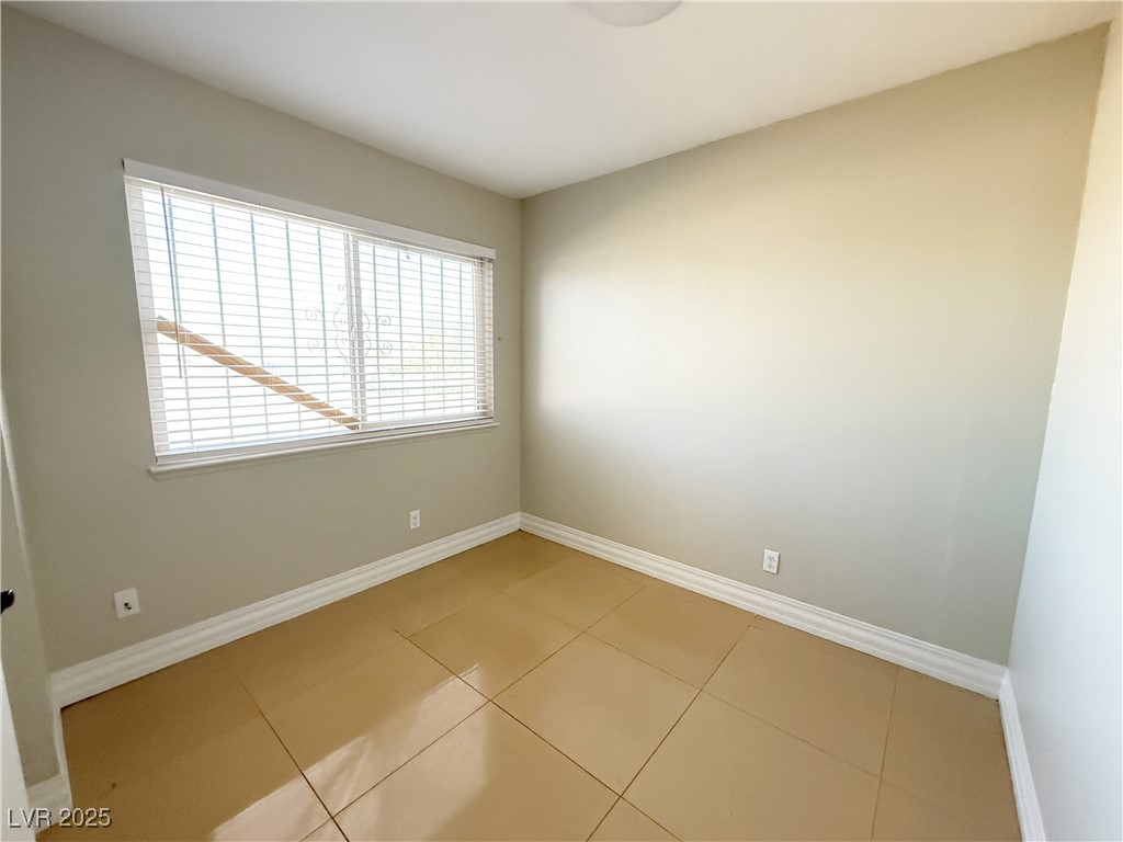 2353 Exeter Drive, Unit B Las Vegas, NV 89156 - Photo 6 of 16 Empty room with baseboards and tile patterned floors