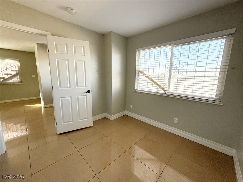 2353 Exeter Drive, Unit B Las Vegas, NV 89156 - Photo 7 of 16 Unfurnished bedroom featuring light tile patterned floors and baseboards