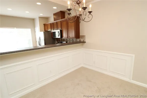 a view of kitchen and hall with wooden floor