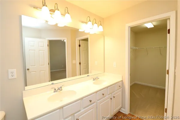 a bathroom with a tub sink and shower