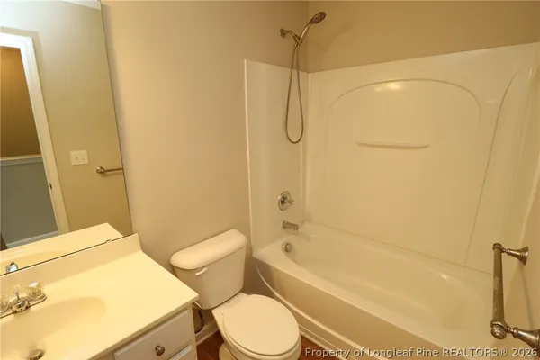 a balcony with wooden floor and trees in the background