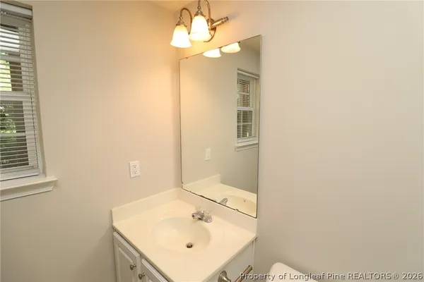 a bathroom with a sink a mirror and a toilet