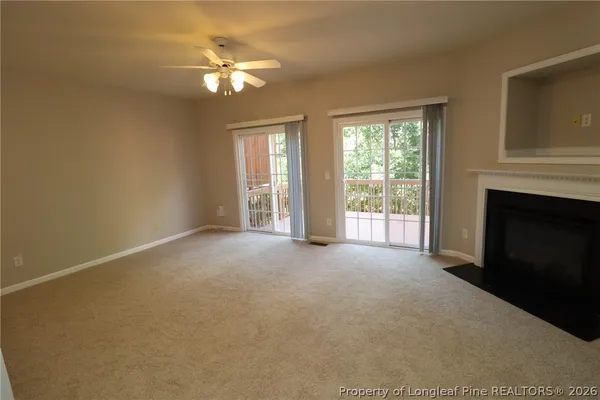 a view of a livingroom with a ceiling fan and window