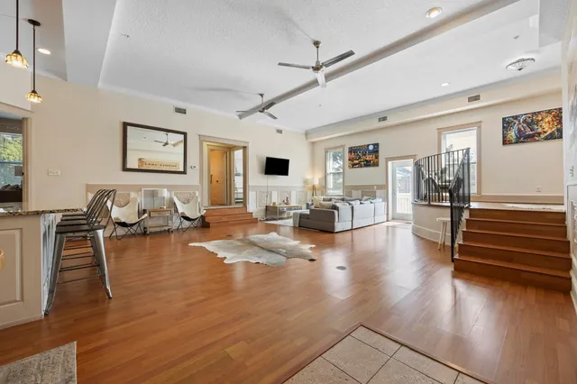 a bathroom with a granite countertop toilet a sink and a mirror