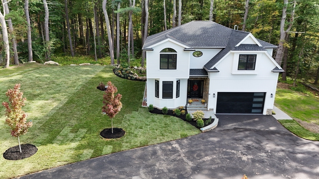 53 Cider Mill Lane Upton, MA 01568 - Photo 3 of 40 a front view of a house with garden