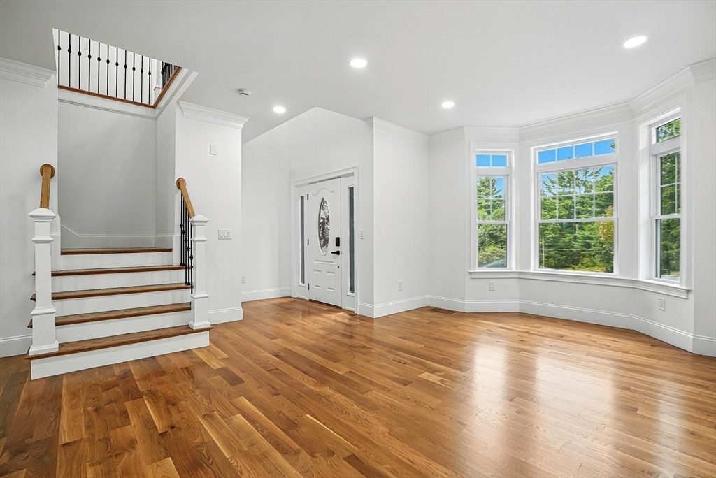 53 Cider Mill Lane Upton, MA 01568 - Photo 4 of 40 a view of an empty room with wooden floor and a window