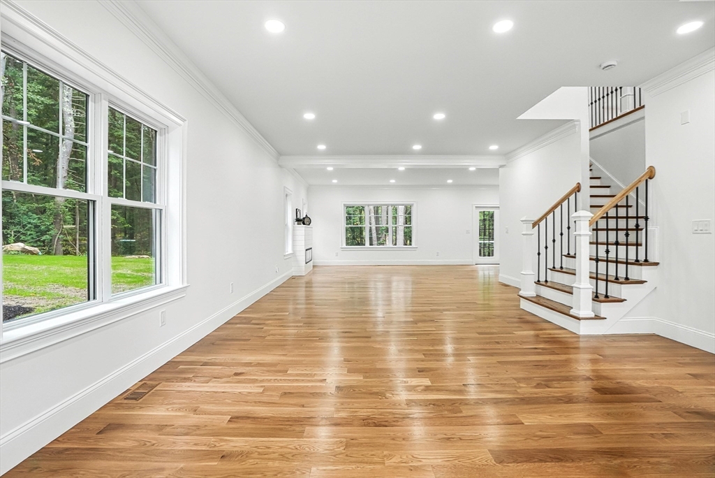 53 Cider Mill Lane Upton, MA 01568 - Photo 7 of 40 a view of an empty room with wooden floor and a window