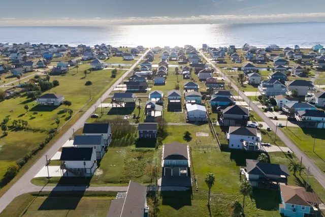 an aerial view of residential houses with outdoor space and swimming pool
