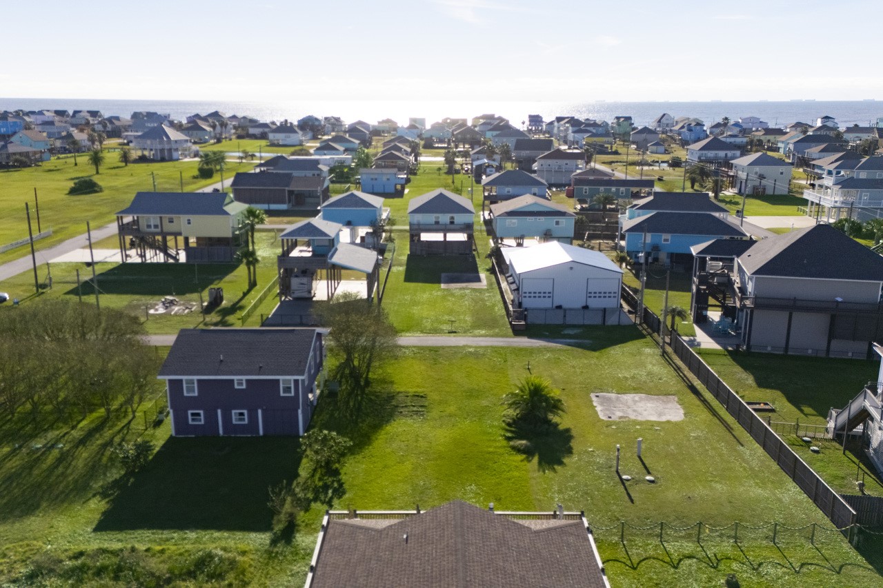 2109 1st Street Crystal Beach, TX 77650 - Photo 13 of 14 an aerial view of residential houses with outdoor space and swimming pool