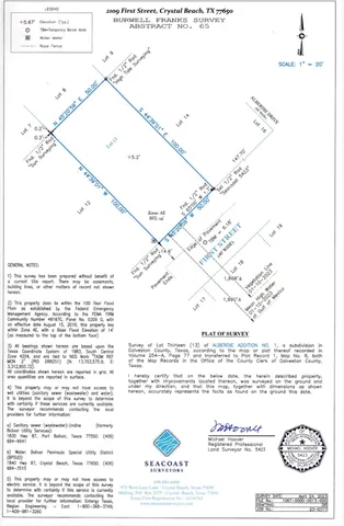 a swimming pool that has lawn chairs and a dining table