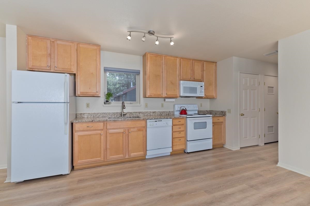 550 Mono Street, Unit C202 Mammoth Lakes, CA 93546 - Photo 6 of 36 a kitchen with granite countertop a refrigerator stove top oven and sink