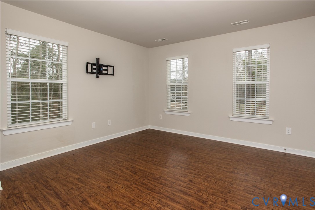 1561 Burning Tree Road Henrico, VA 23231 - Photo 11 of 29 a view of an empty room with wooden floor and windows