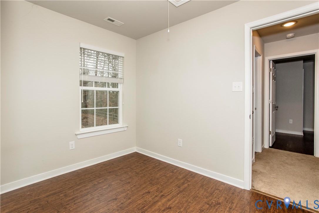 1561 Burning Tree Road Henrico, VA 23231 - Photo 19 of 29 an empty room with wooden floor and windows