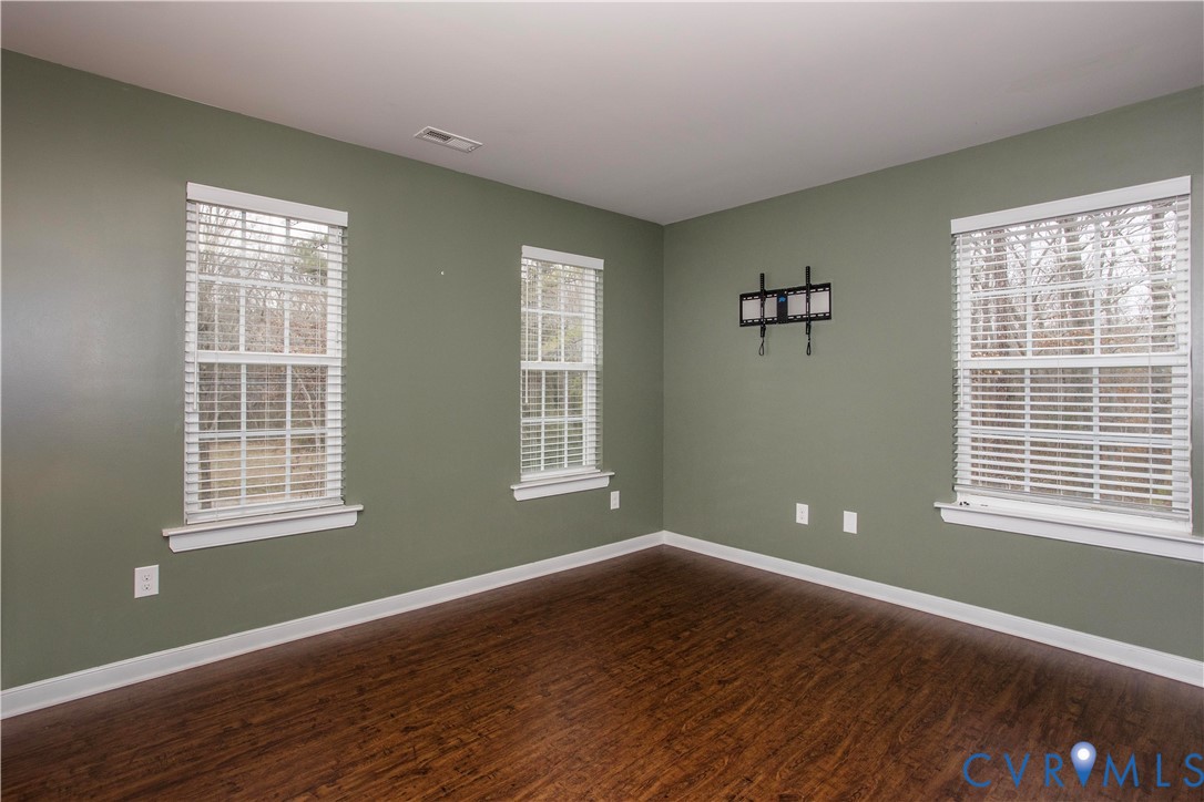 1561 Burning Tree Road Henrico, VA 23231 - Photo 20 of 29 a view of an empty room with wooden floor and a window