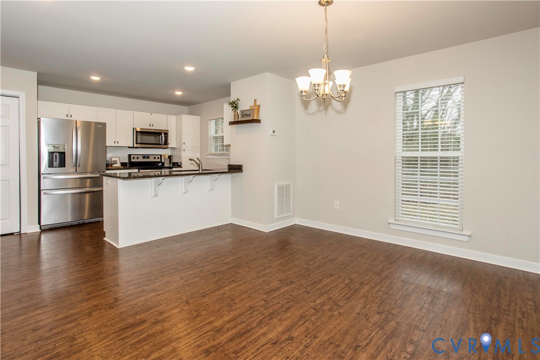 1561 Burning Tree Road Henrico, VA 23231 - Photo 2 of 29 a view of a kitchen with stove and wooden floor