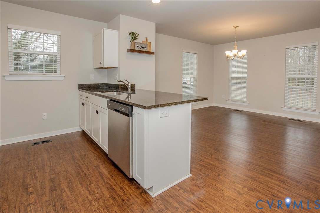 1561 Burning Tree Road Henrico, VA 23231 - Photo 4 of 29 a kitchen with granite countertop a stove and a wooden floors