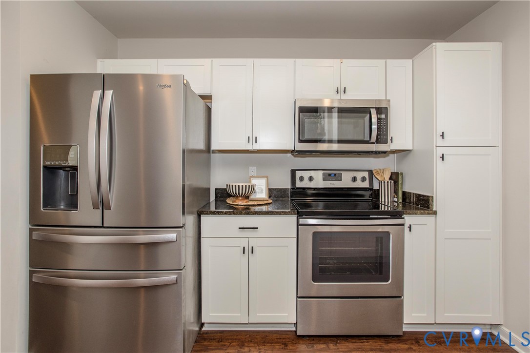 1561 Burning Tree Road Henrico, VA 23231 - Photo 6 of 29 a kitchen with cabinets stainless steel appliances and wooden floor