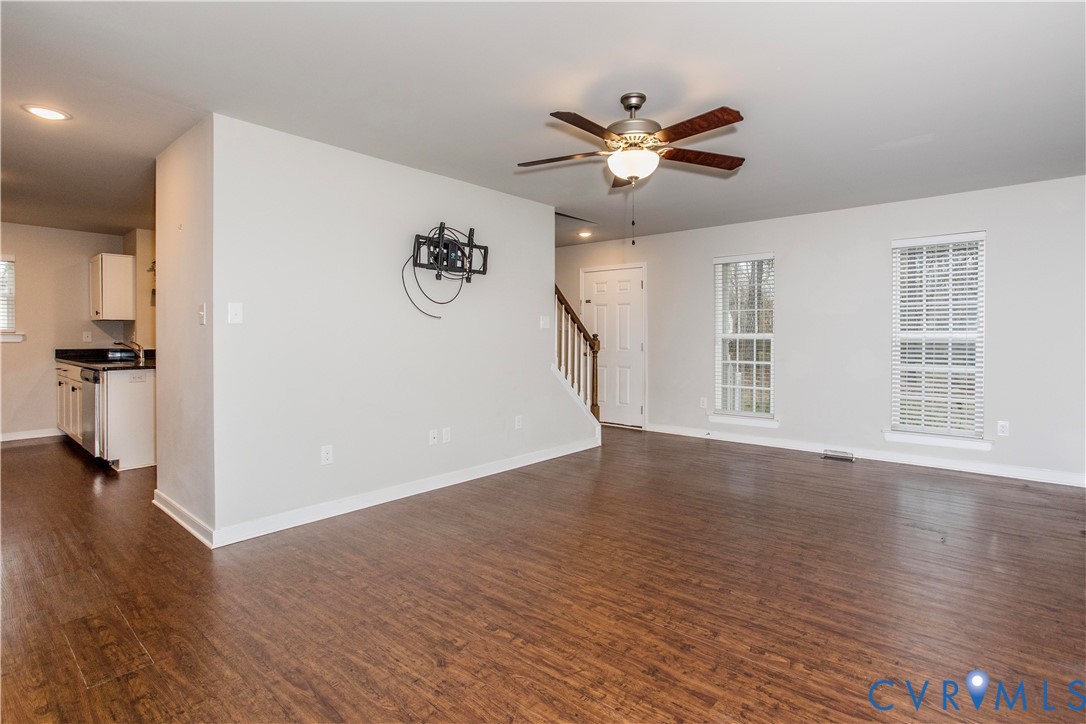 1561 Burning Tree Road Henrico, VA 23231 - Photo 8 of 29 a view of a livingroom with wooden floor a ceiling fan and windows