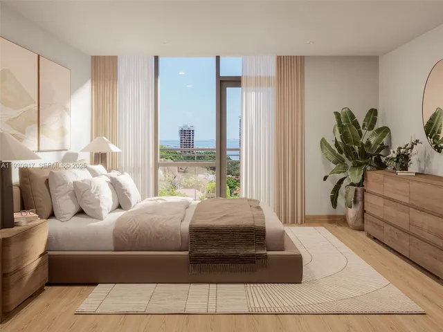 a living room with a bed furniture and a potted plant