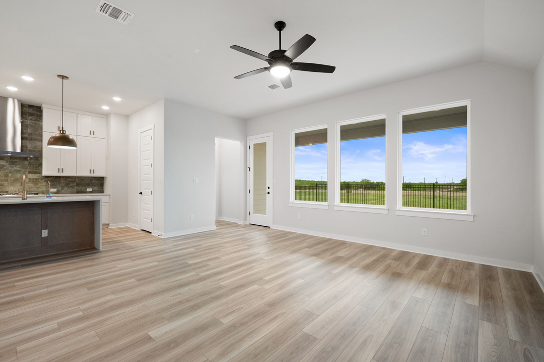 16201 Smithers Road Manor, TX 78653 - Photo 11 of 40 a view of an empty room with a kitchen and a sink