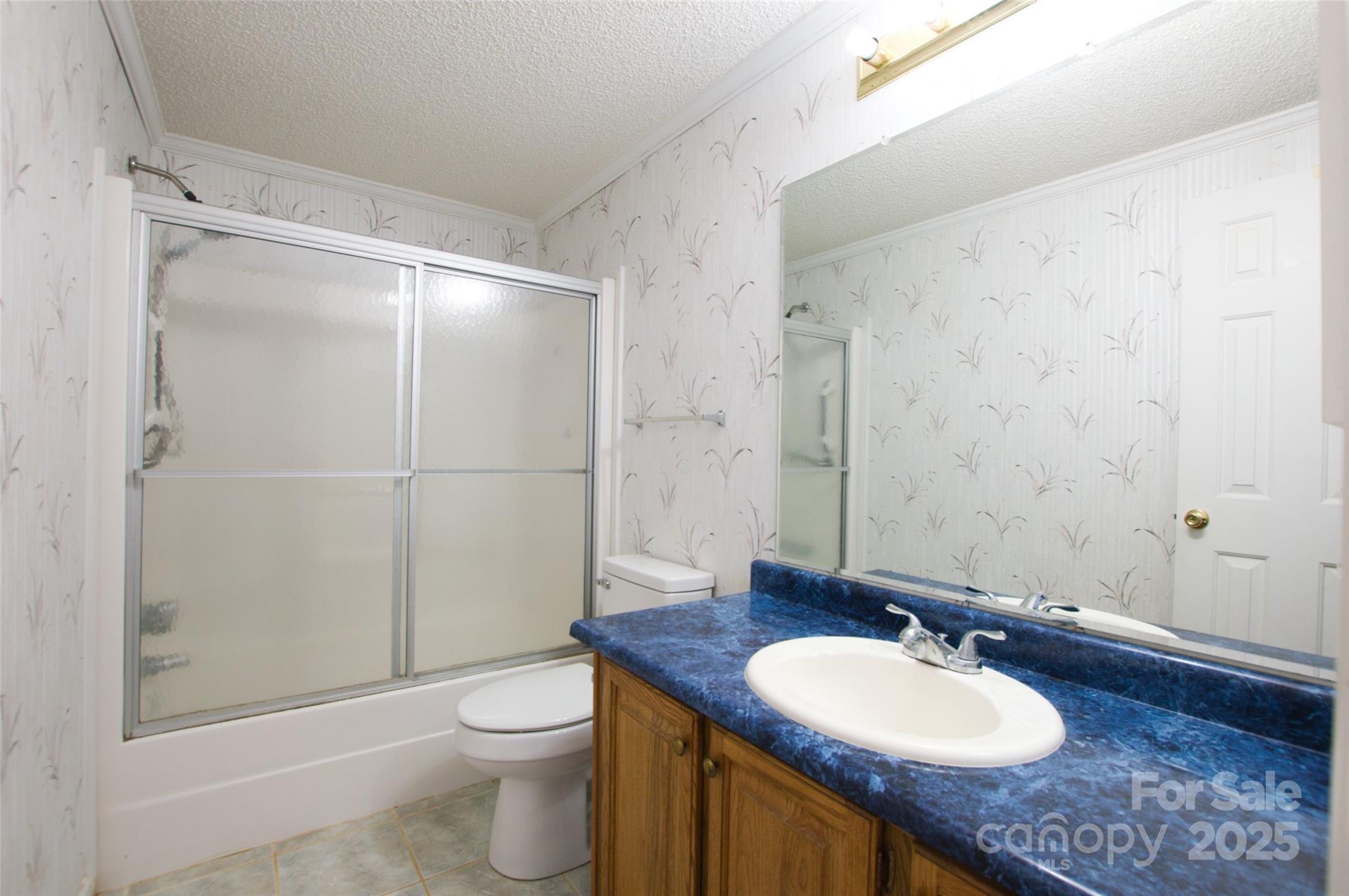 150 Orindawood Road McConnells, SC 29726 - Photo 20 of 21 a bathroom with a granite countertop sink toilet a mirror and shower