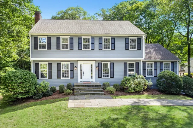 a front view of a house with a yard and porch