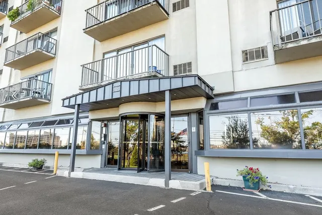 a view of a building with a window and sitting area