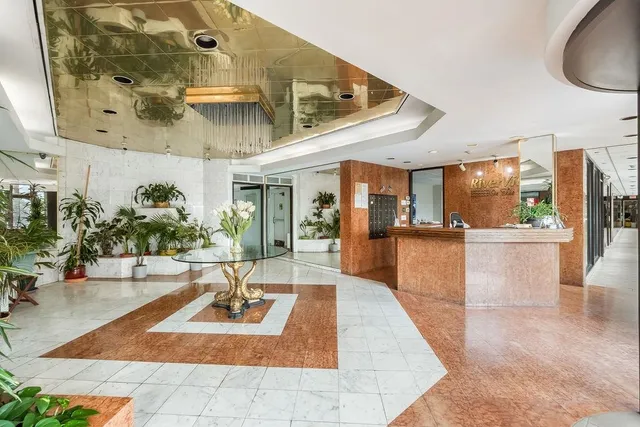 a lobby with furniture and floor to ceiling window