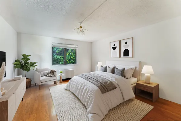 a bedroom with a large bed and a couch