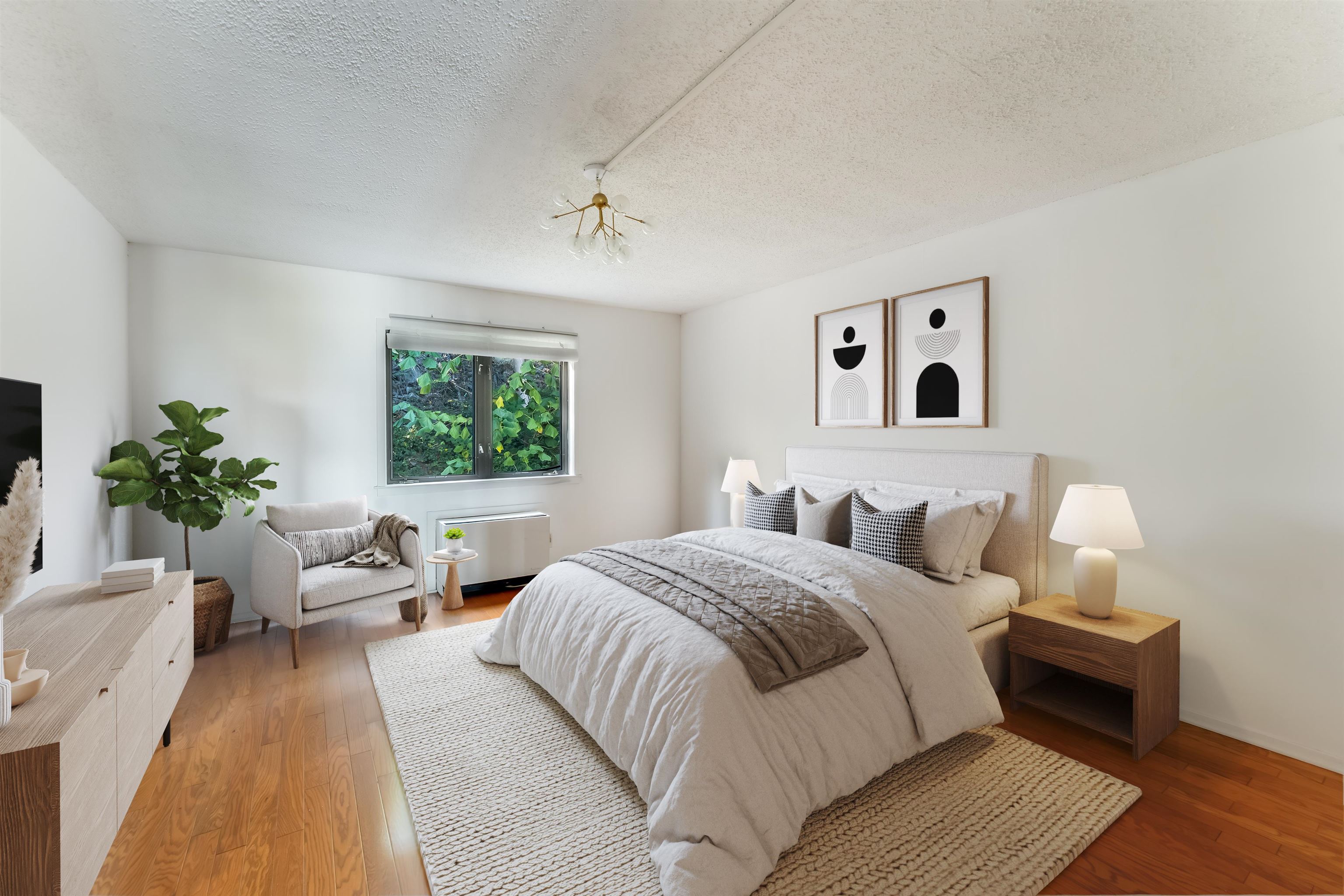 1150 River Road, Unit 4F Edgewater, NJ 07020 - Photo 2 of 20 a bedroom with a large bed and a couch