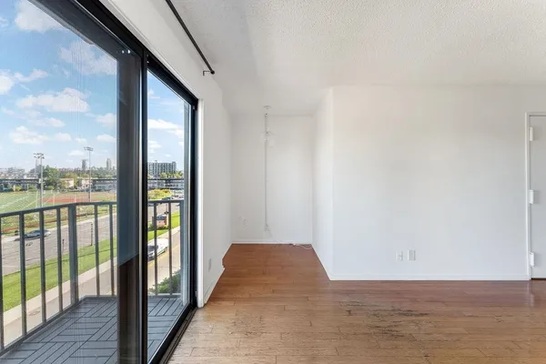a view of a hallway with wooden floor and fence