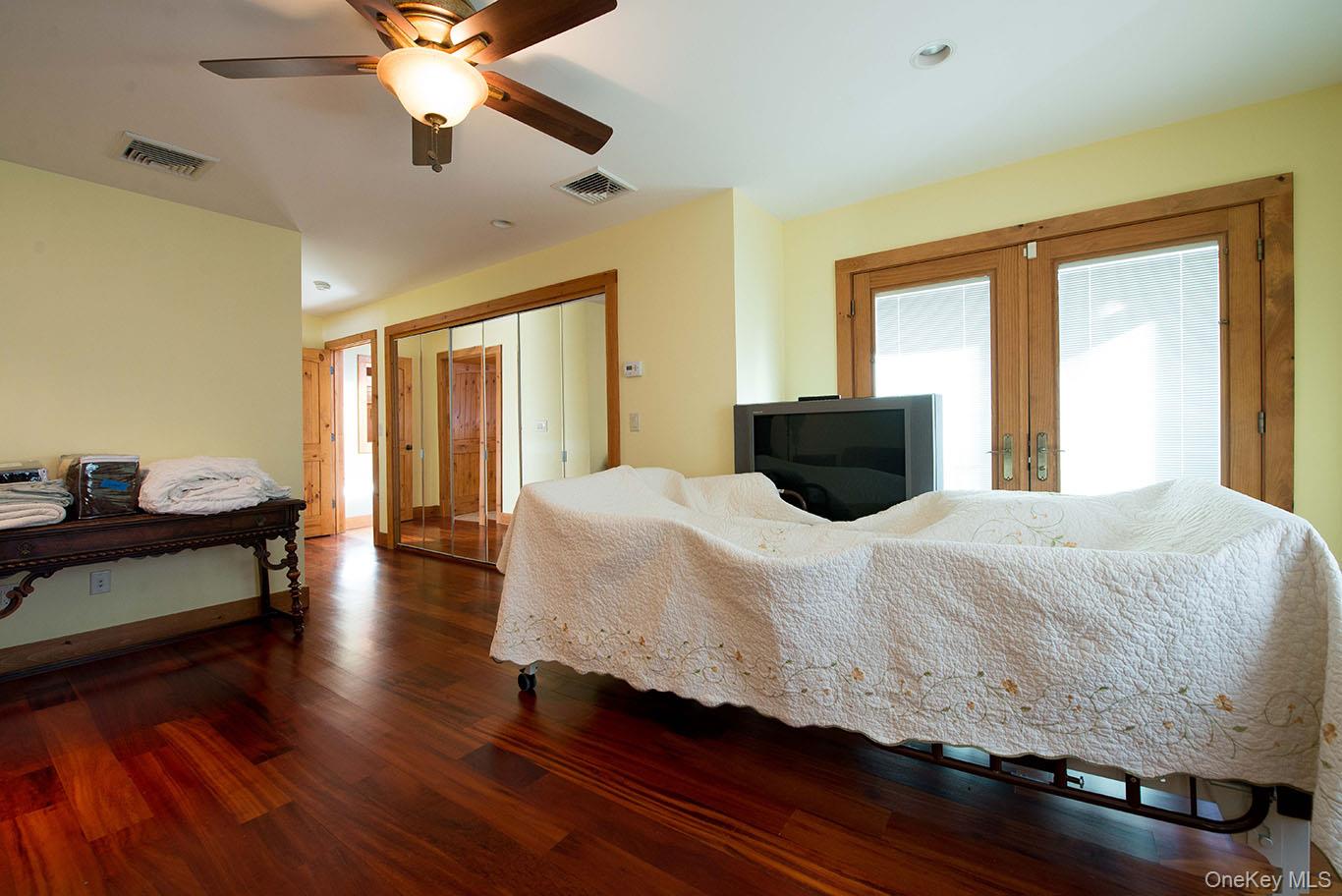 1644 Lakes Road Monroe, NY 10950 - Photo 25 of 49 a bedroom with a bed and wooden floor