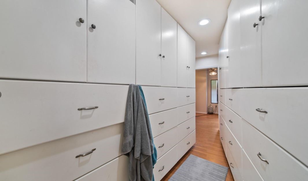 6714 Spray Lane, Unit C699A Rosharon, TX 77583 - Photo 19 of 48 Huge owner's Walk0In Closet with Custom Cabinetry - Additional Updates include - New Blown in Insulation completed Feb 2023