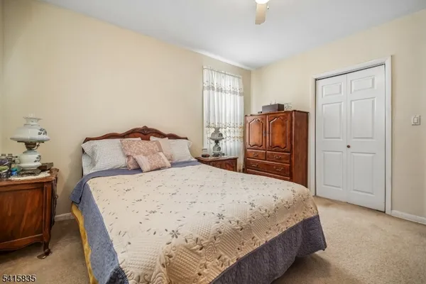 a bedroom with a bed and wooden furniture