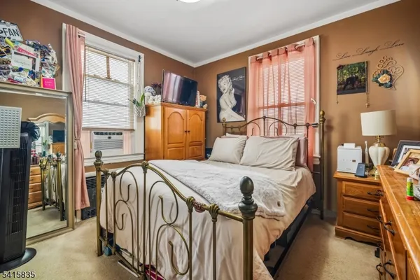 a bedroom with furniture and a window