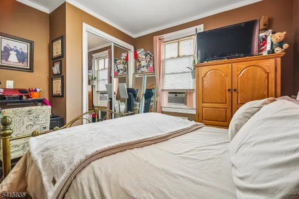 a bedroom with bed and wooden floor