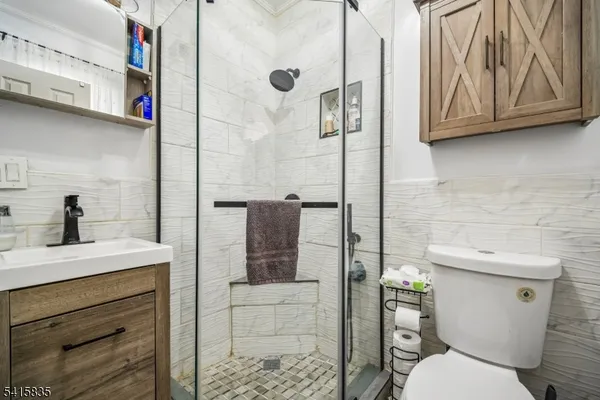 a bathroom with a toilet and a shower