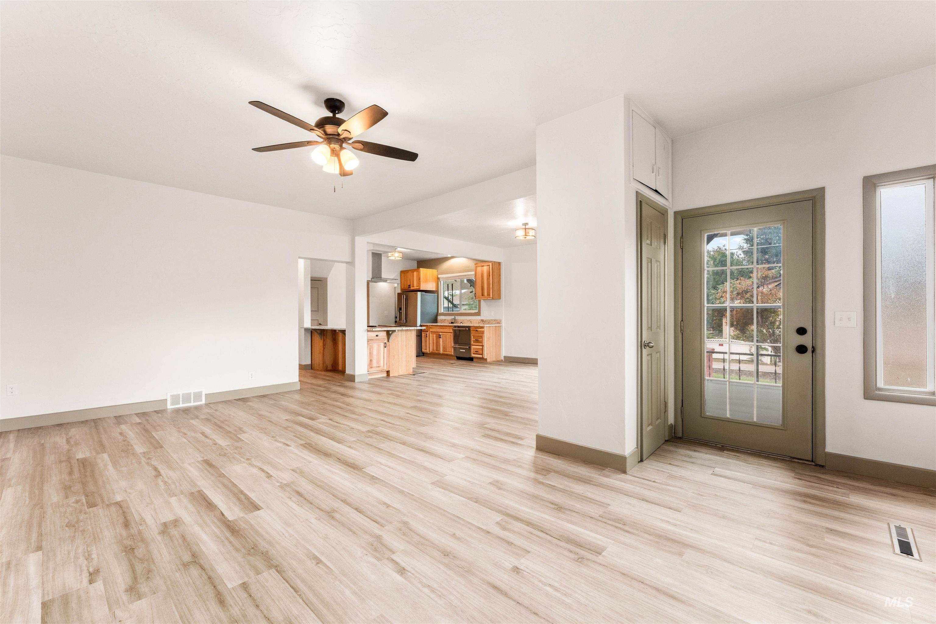 602 North 5th Street Parma, ID 83660 - Photo 13 of 48 Unfurnished living room featuring light wood finished floors and ceiling fan