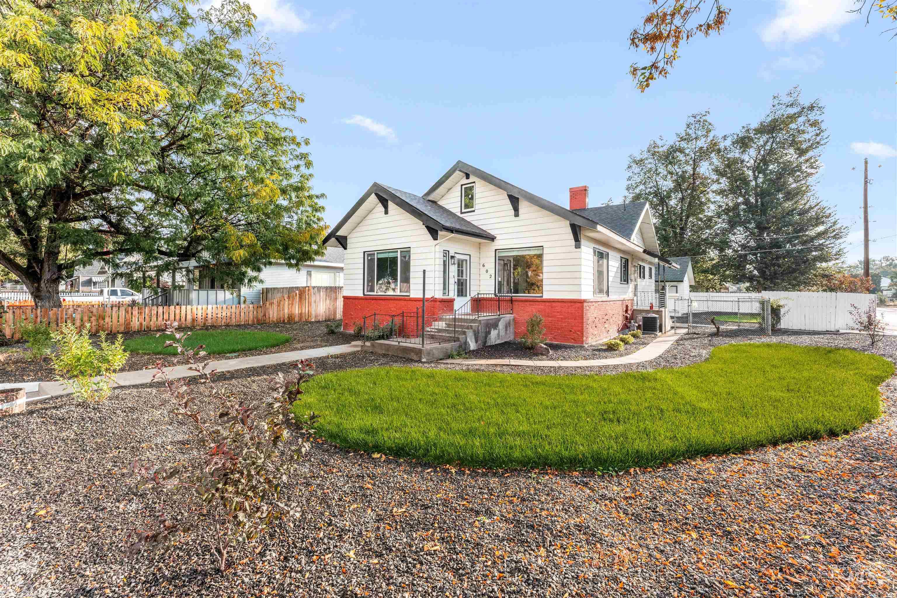 602 North 5th Street Parma, ID 83660 - Photo 2 of 48 Rear view of house featuring a chimney and brick siding