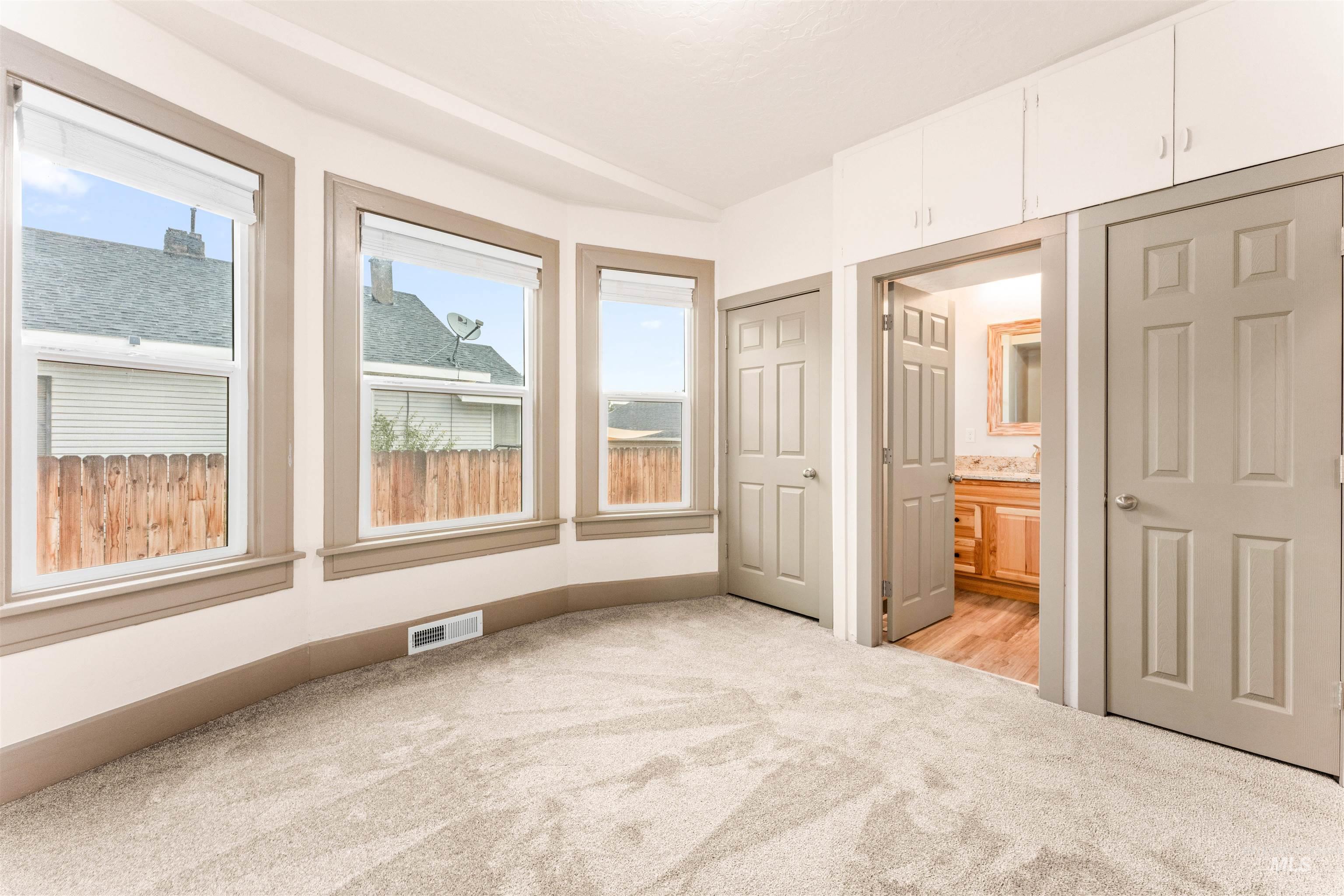 602 North 5th Street Parma, ID 83660 - Photo 24 of 48 Unfurnished bedroom featuring light carpet, ensuite bathroom, and a closet