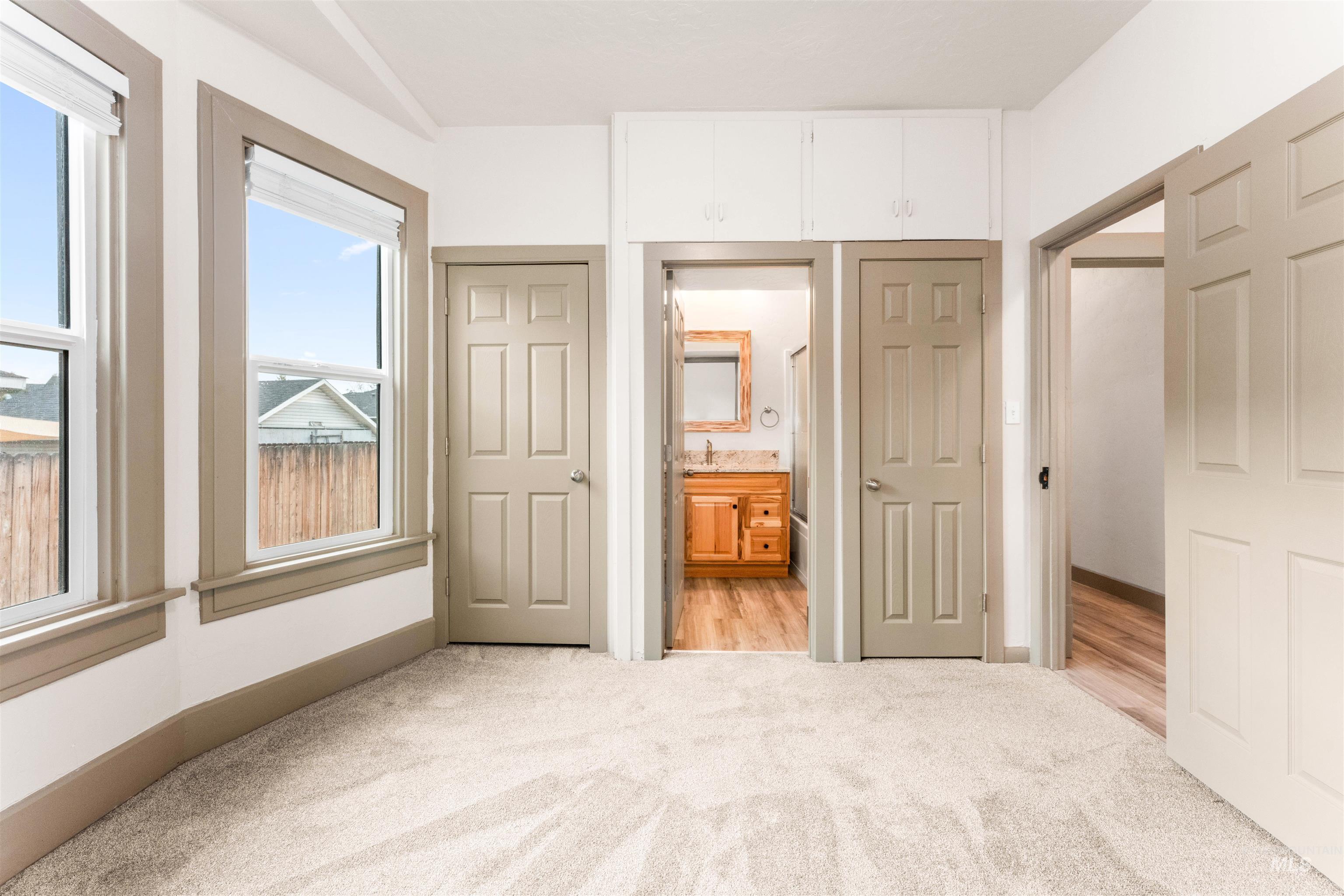 602 North 5th Street Parma, ID 83660 - Photo 25 of 48 Unfurnished bedroom with light colored carpet, connected bathroom, and a closet