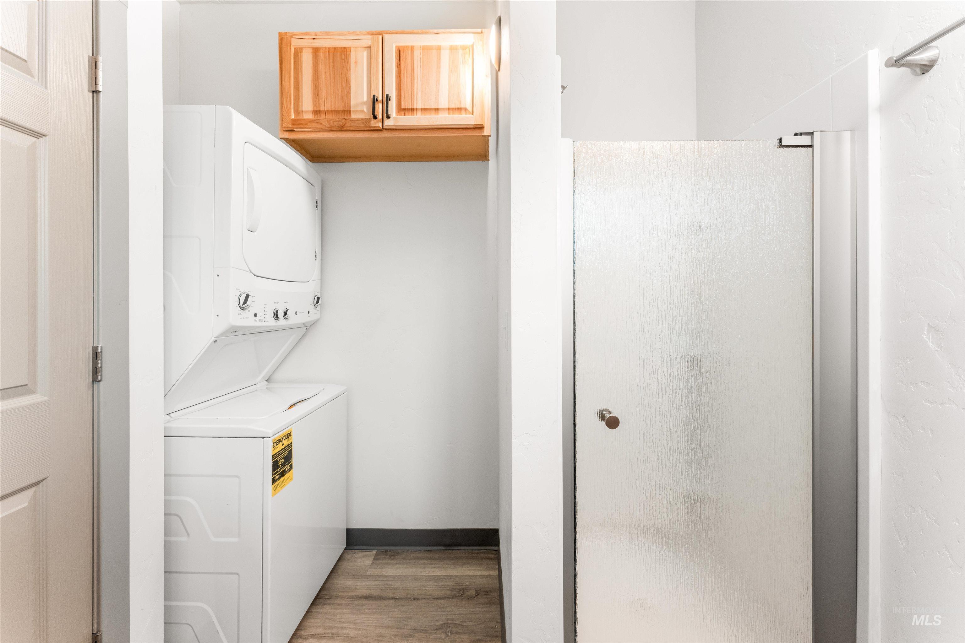 602 North 5th Street Parma, ID 83660 - Photo 29 of 48 Washroom featuring light wood-type flooring and stacked washer and clothes dryer
