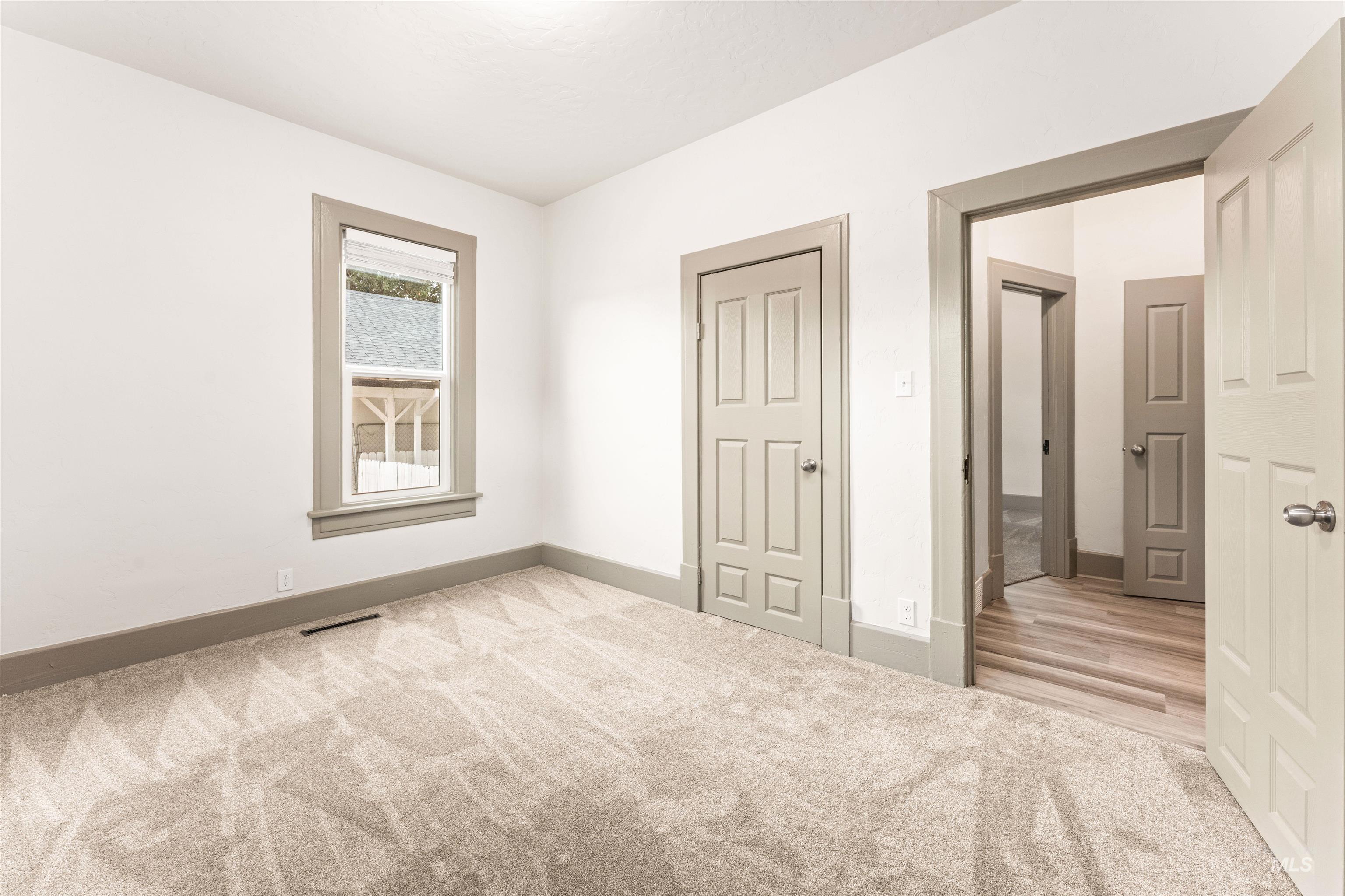 602 North 5th Street Parma, ID 83660 - Photo 31 of 48 Unfurnished bedroom featuring light carpet and baseboards